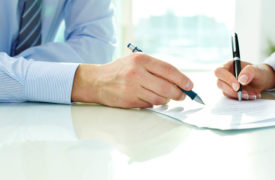 Businessman signing insurance document