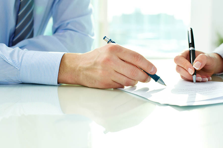 Businessman signing insurance document