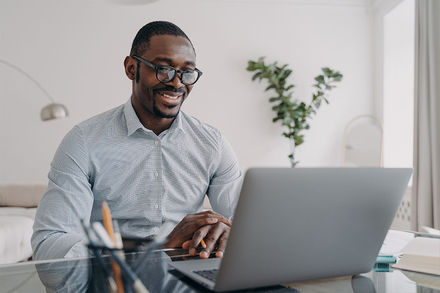 African American Man working remote on zoom home office call