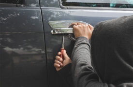 Thief breaking into car