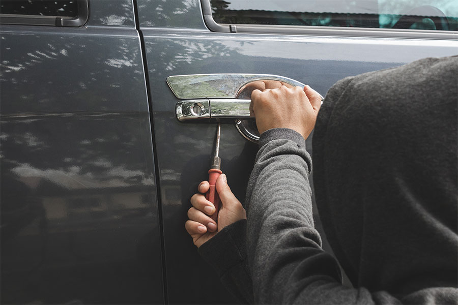 Thief breaking into car