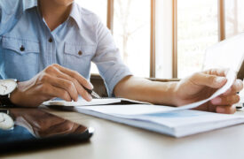 Business man reviews insurance documents on the desk at the office.