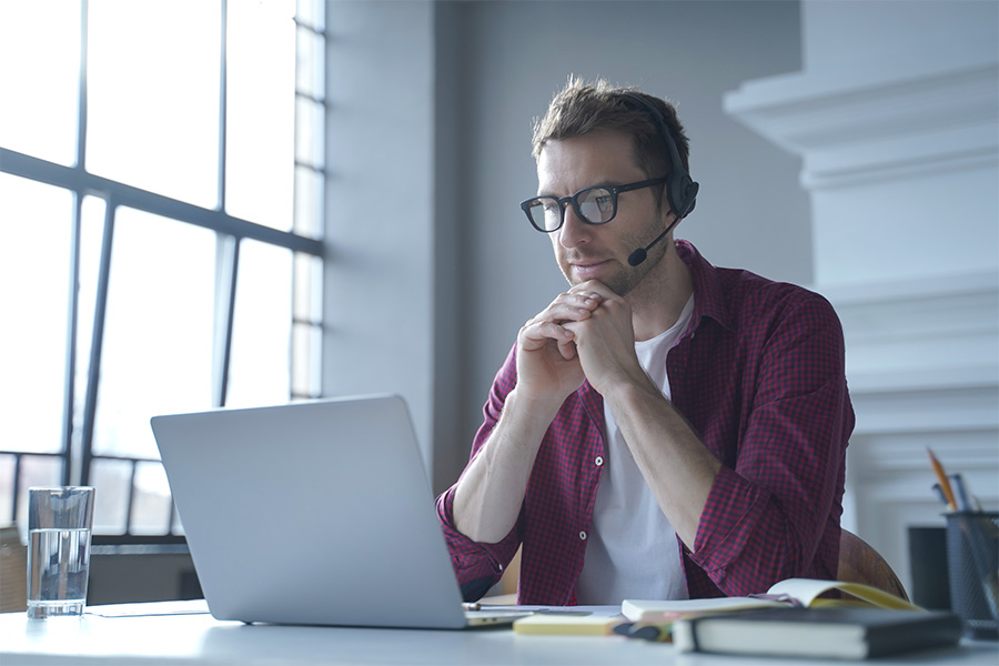 Business Man Thinking at Laptop in Office